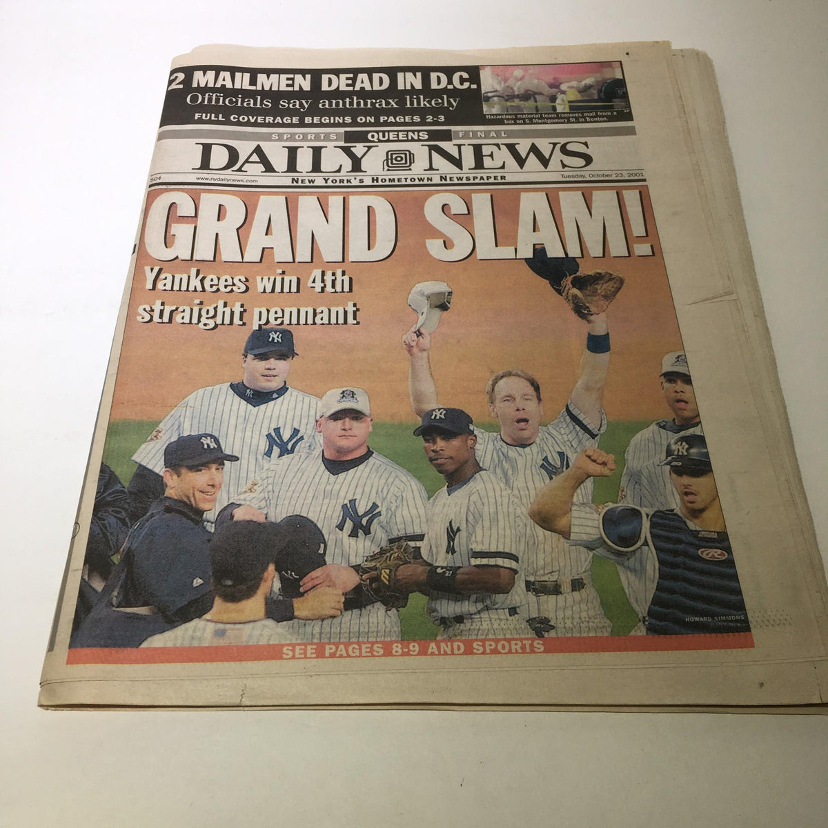 NY Daily News front page from October 23, 2001, featuring the headline 'Grand Slam! Yankees win 4th straight pennant' with players celebrating.