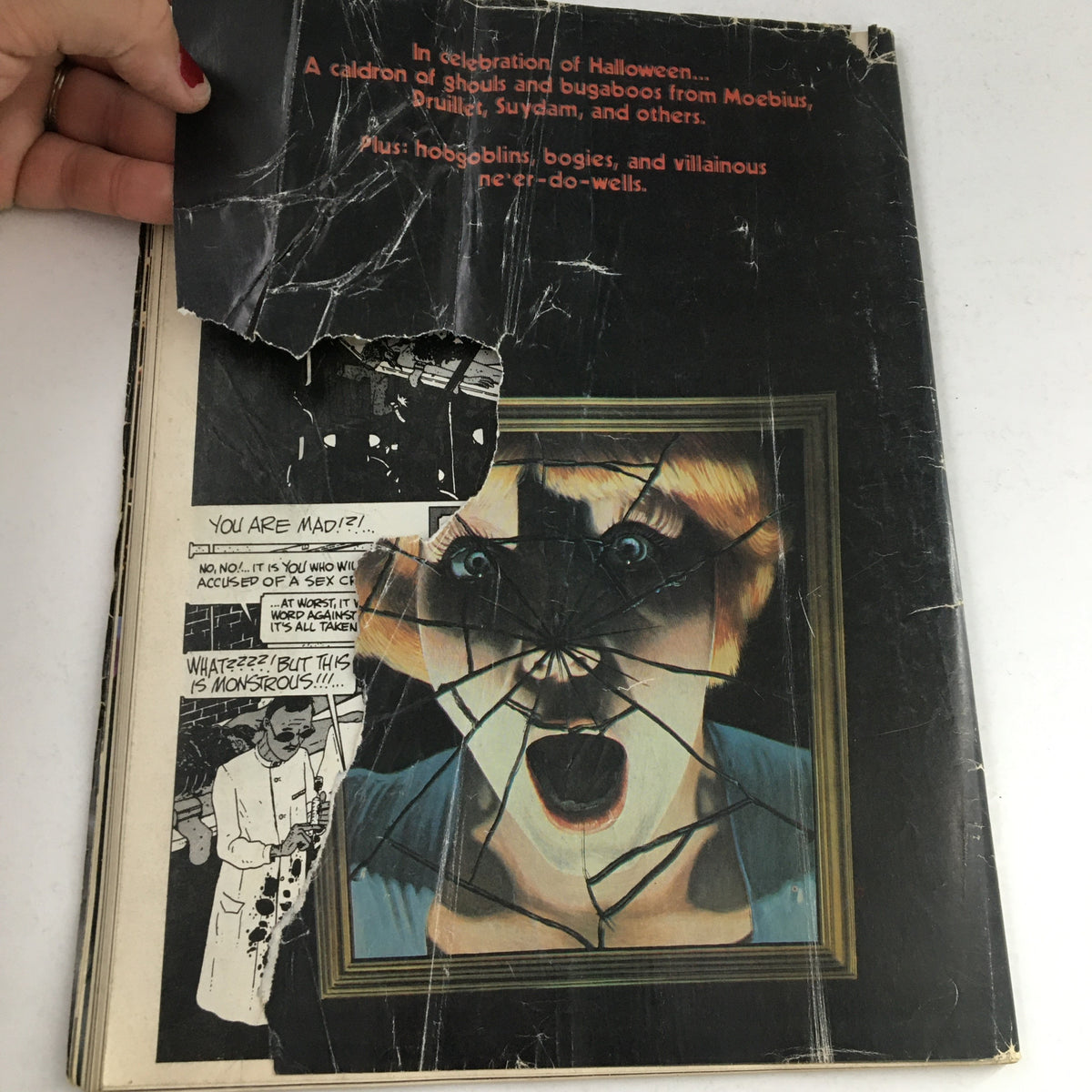 Back cover of Heavy Metal Magazine October 1979 featuring a striking visual with a cracked mirror effect and text related to Halloween themes.
