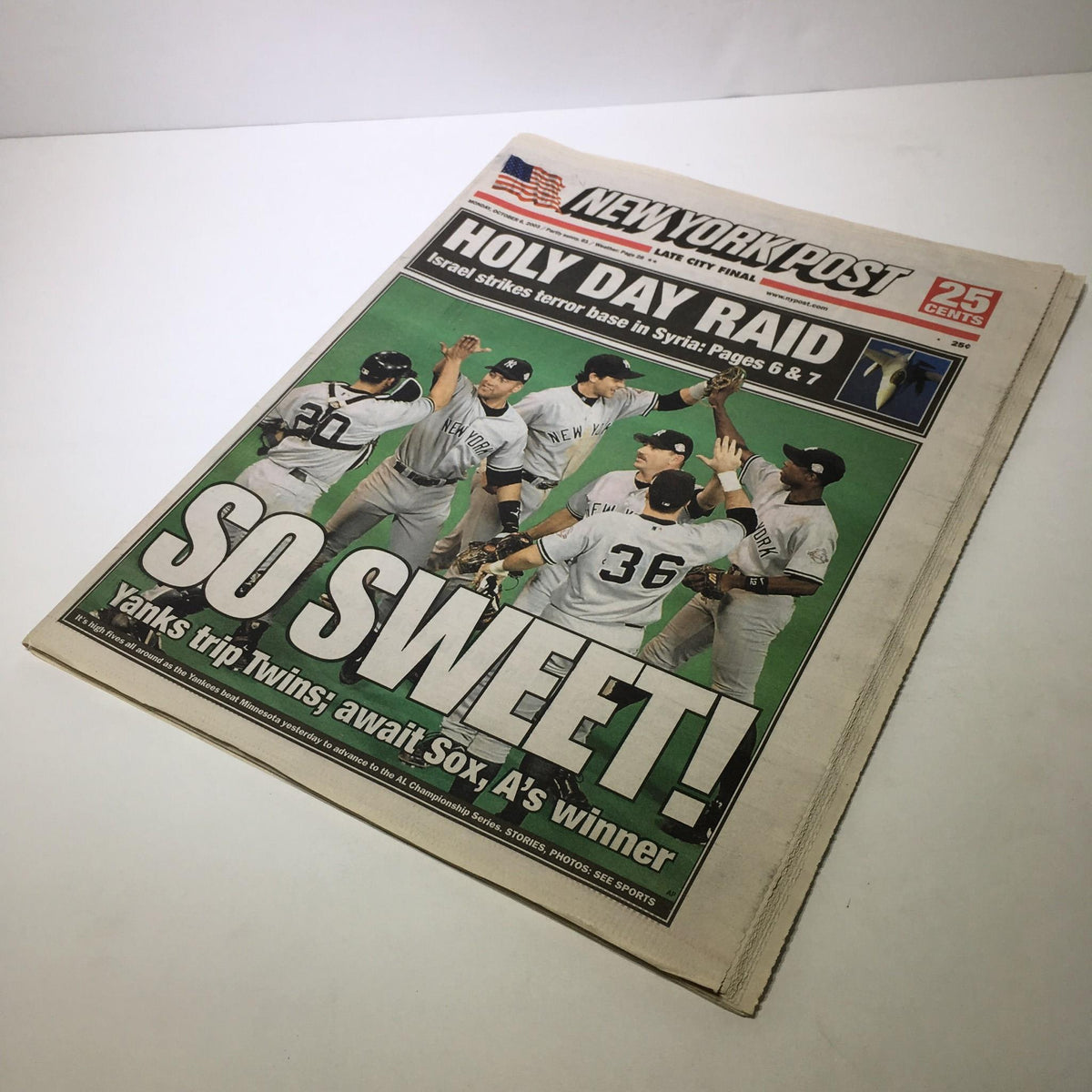 Another view of the New York Post front page from October 6, 2003, featuring the headline "SO SWEET! Yanks trip Twins; Await Sox, A's winner" with a vibrant green background and Yankees players.