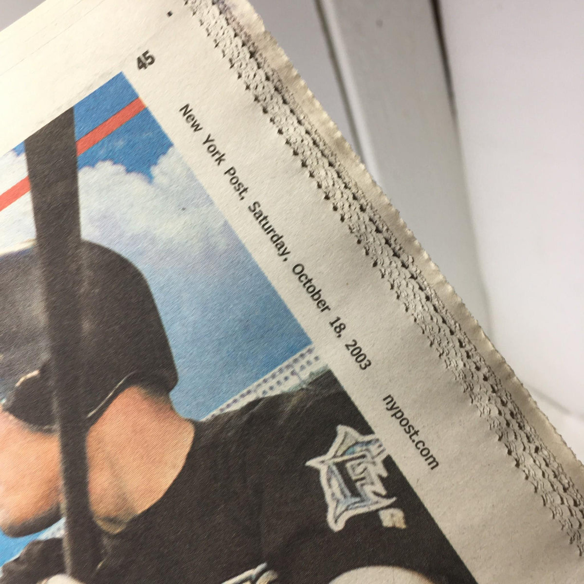 Close-up of New York Post dated Saturday, October 18, 2003, highlighting the publication details with a baseball player in a batting stance.