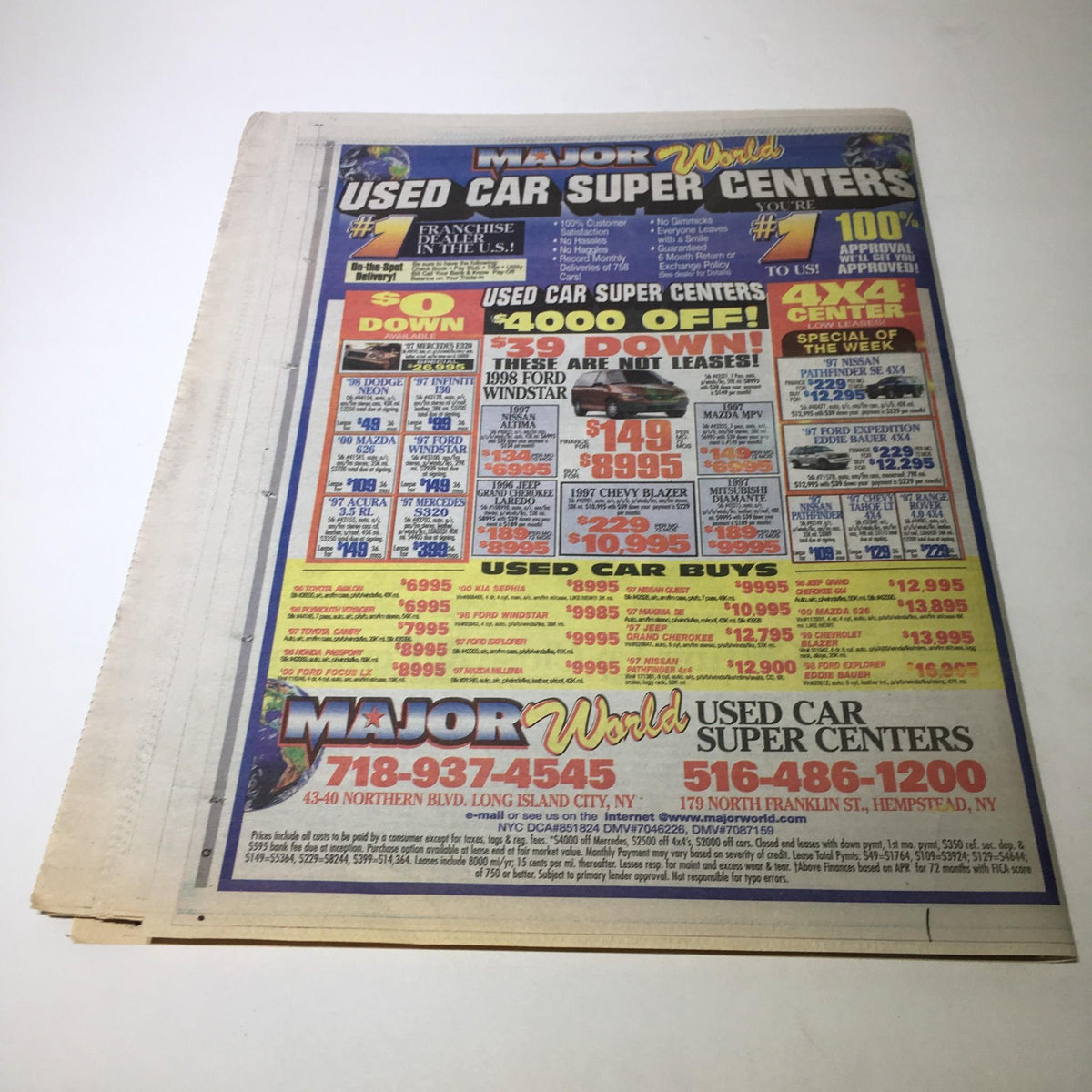 Advertisement for Major World Used Car Super Centers featured on the back of Newsday from October 22, 2000, highlighting car deals and promotions.