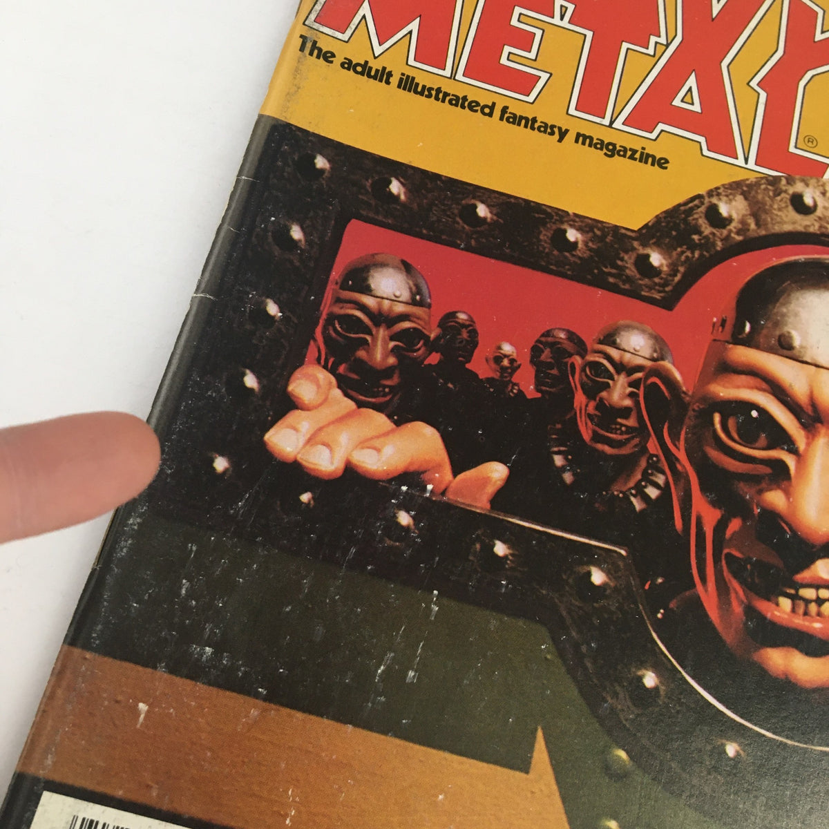 Close-up view of the cover of Heavy Metal Magazine August 1982 highlighting the intricate details of the artwork and a character's outstretched hand.