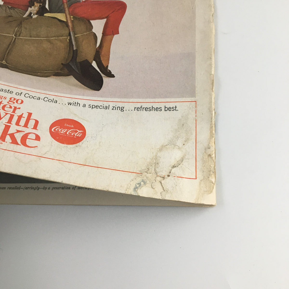 The back cover of The Saturday Evening Post May 30 1964 showing a vintage Coca-Cola advertisement and the wear indicative of its age, highlighting its collectible value.