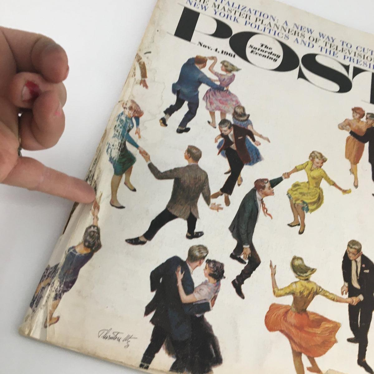 Close-up of The Saturday Evening Post cover from November 4, 1961, highlighting the dance scene and an individual's finger pointing at the cover with New York Politics and The Presidency theme.