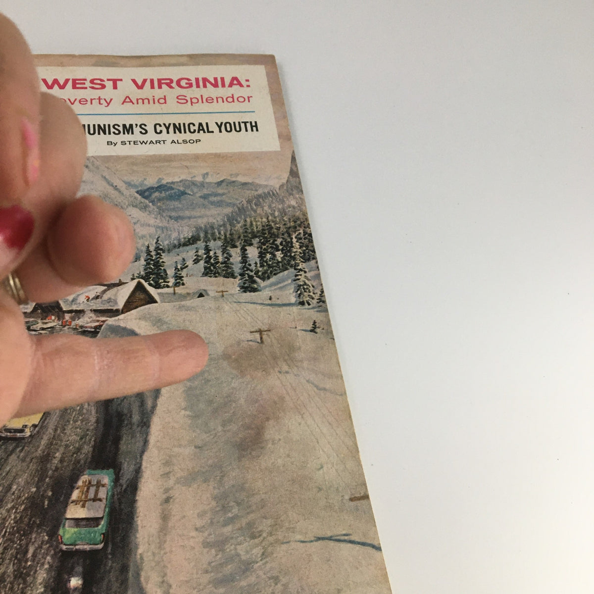 The Saturday Evening Post cover from February 6, 1960, showing the headline 'West Virginia: Poverty Amid Splendor' and a hand pointing to the magazine's snowy landscape illustration.