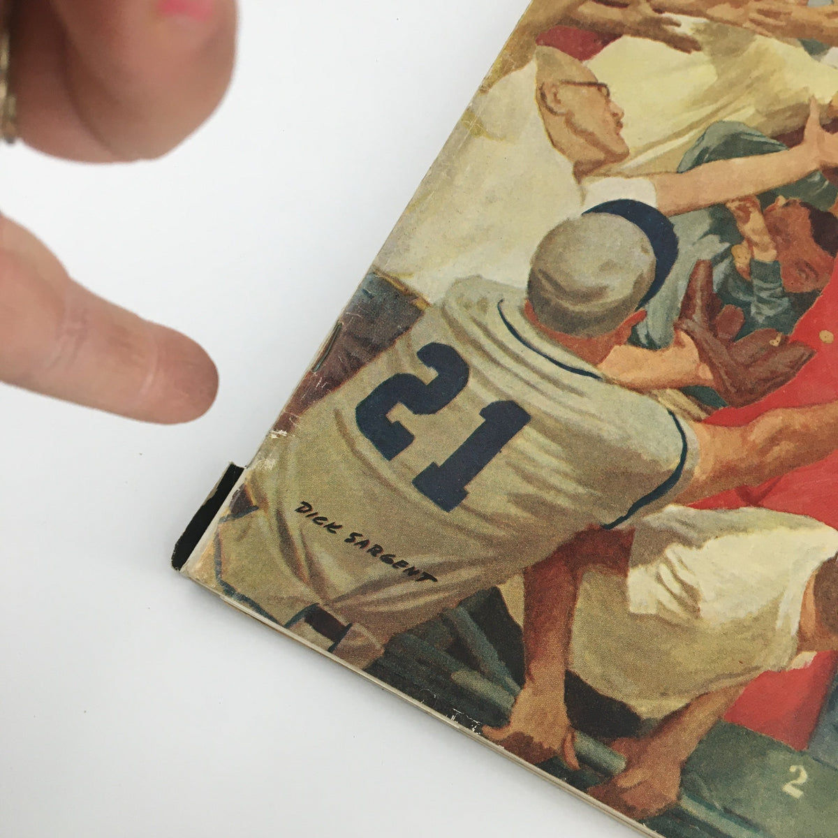 Close-up of the spine of The Saturday Evening Post April 23, 1960, showing the artist's signature 'Dick Sargent' alongside the magazine's edition number.