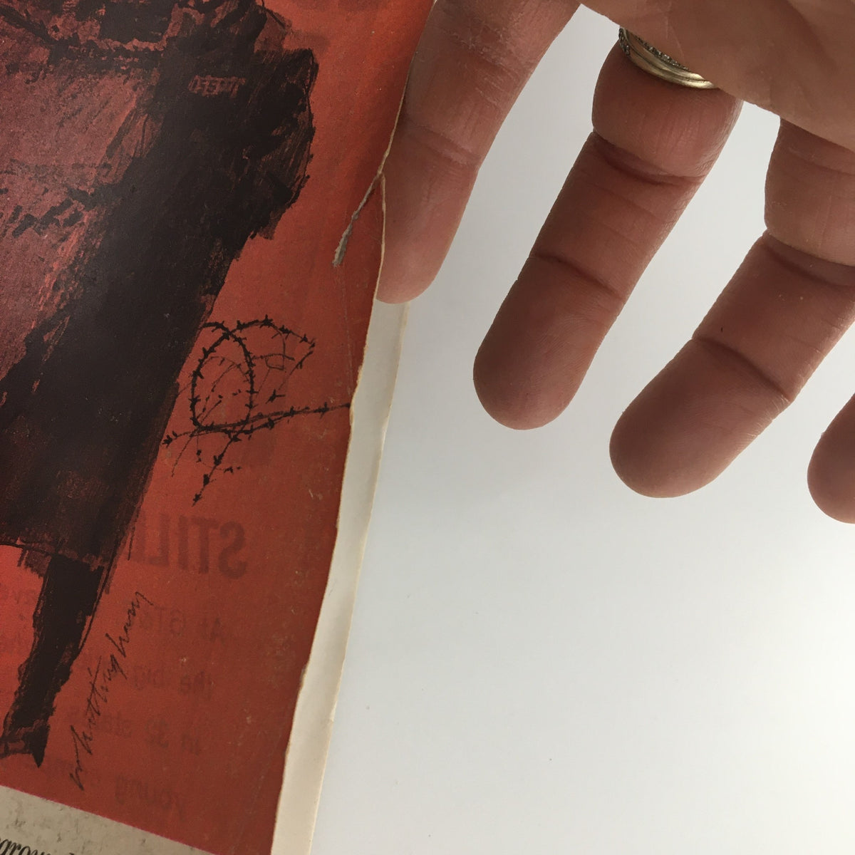 Close-up view of the cover damage on The Saturday Evening Post February 9 1963, highlighting a small rip and edge wear, demonstrating the magazine's vintage condition.
