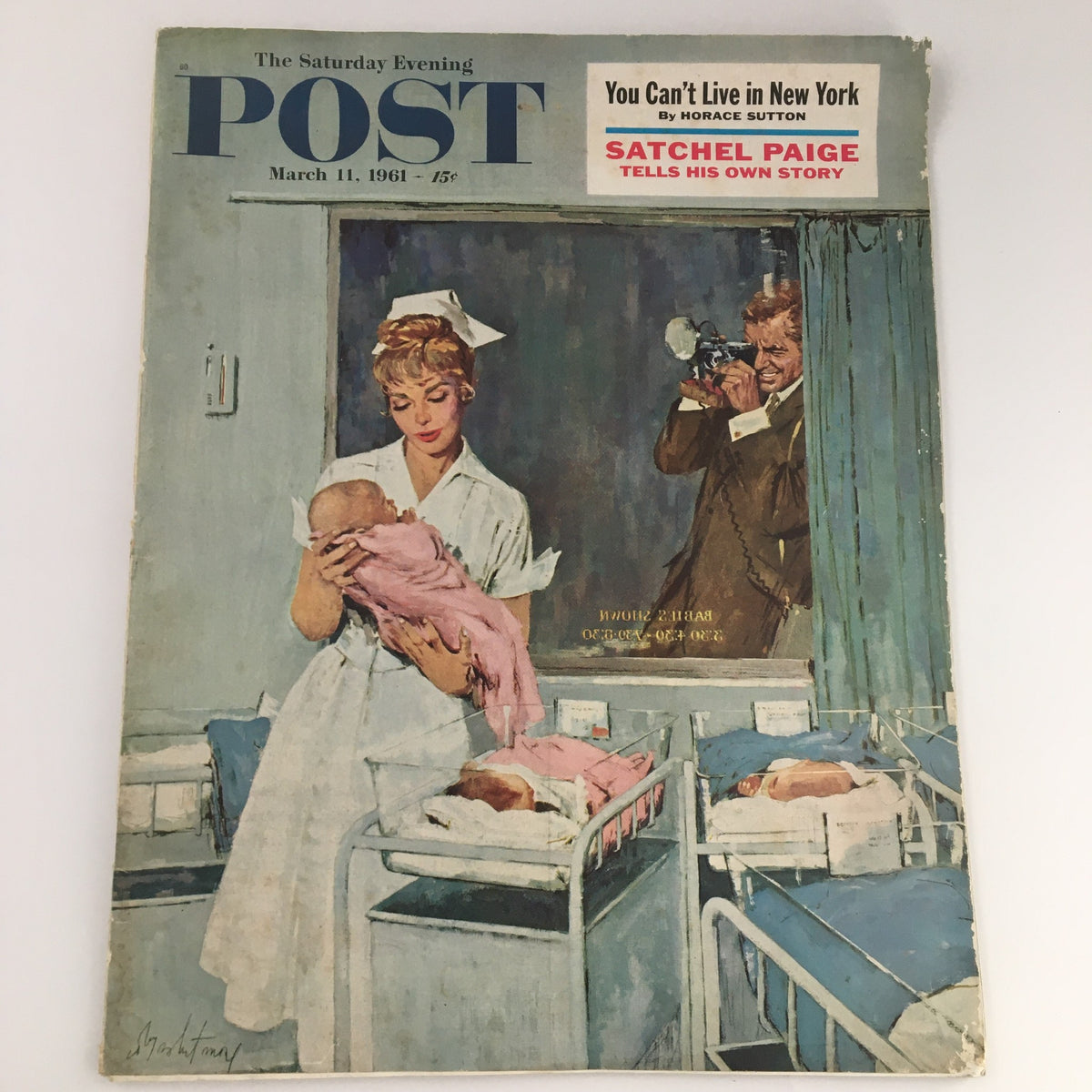 The Saturday Evening Post, March 11, 1961, featuring an illustration of a nurse holding a baby, with cribs in the background, alongside a headline for Satchel Paige's personal story. This vintage magazine showcases American culture and history.
