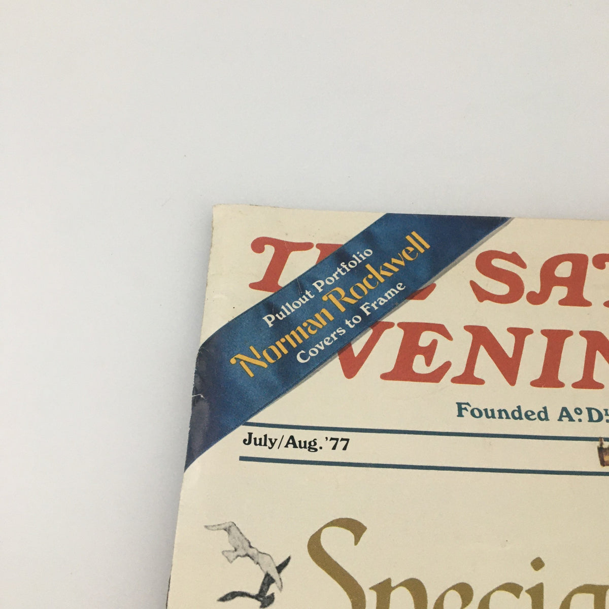 Close-up of The Saturday Evening Post July August 1977 cover showing the 'Pullout Portfolio' blue band and additional magazine details, emphasizing the special anniversary edition.