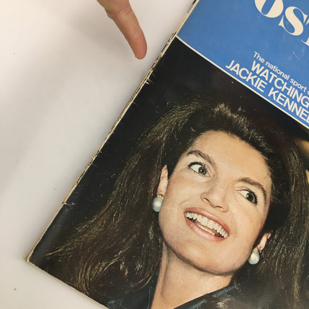Detailed view of The Saturday Evening Post March 11 1967 cover emphasizing Jackie Kennedy's smiling portrait and magazine title, showcasing its historical significance and classic appeal.