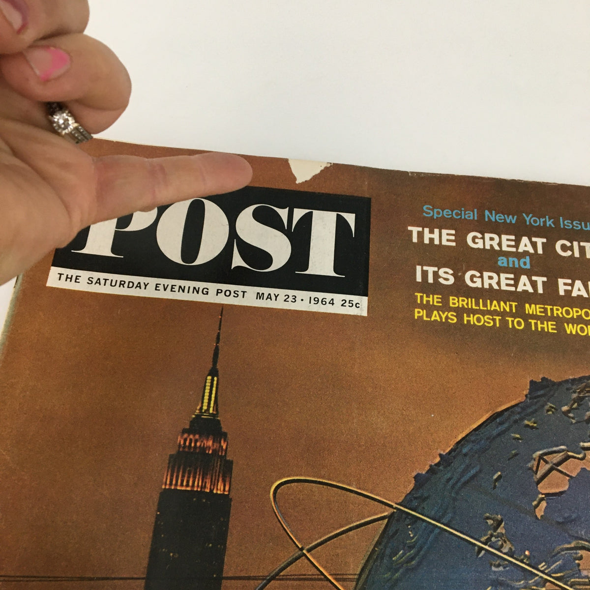 Close-up of The Saturday Evening Post May 23 1964 cover highlighting the title and graphics, including the Empire State Building and globe design, indicative of the magazine's vintage appeal.