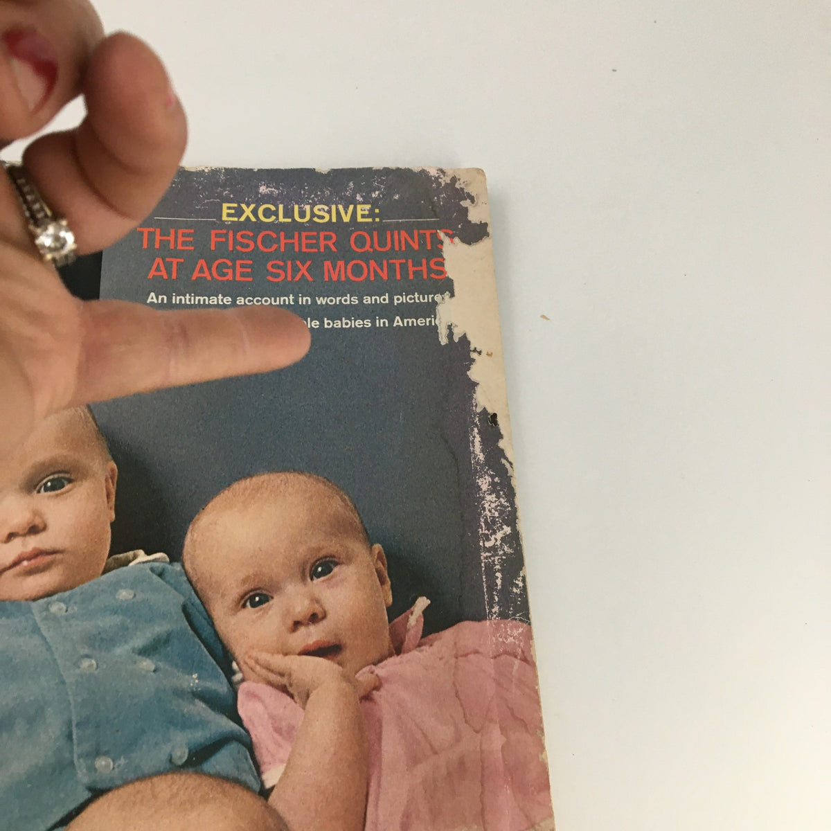 Detailed view of The Saturday Evening Post May 2, 1964, featuring the Fischer Quintuplets at age six months, with the cover text showcasing their story.