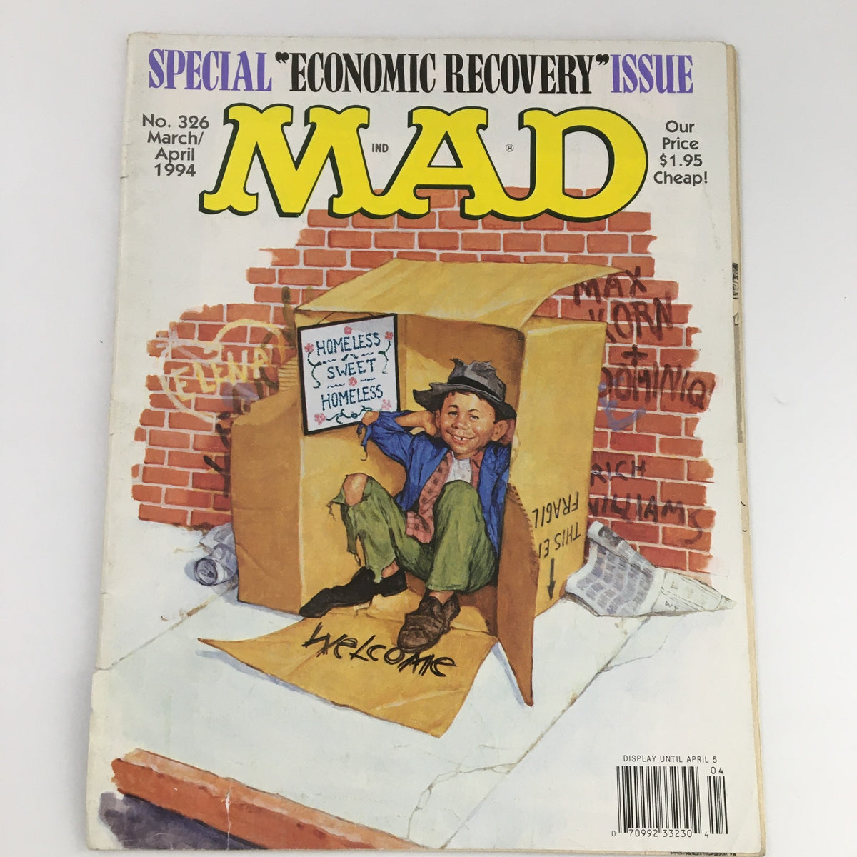 Cover of Mad Magazine March April 1994 #326 Economic Recovery Issue featuring a boy in a cardboard box with a humorous sign about homelessness.