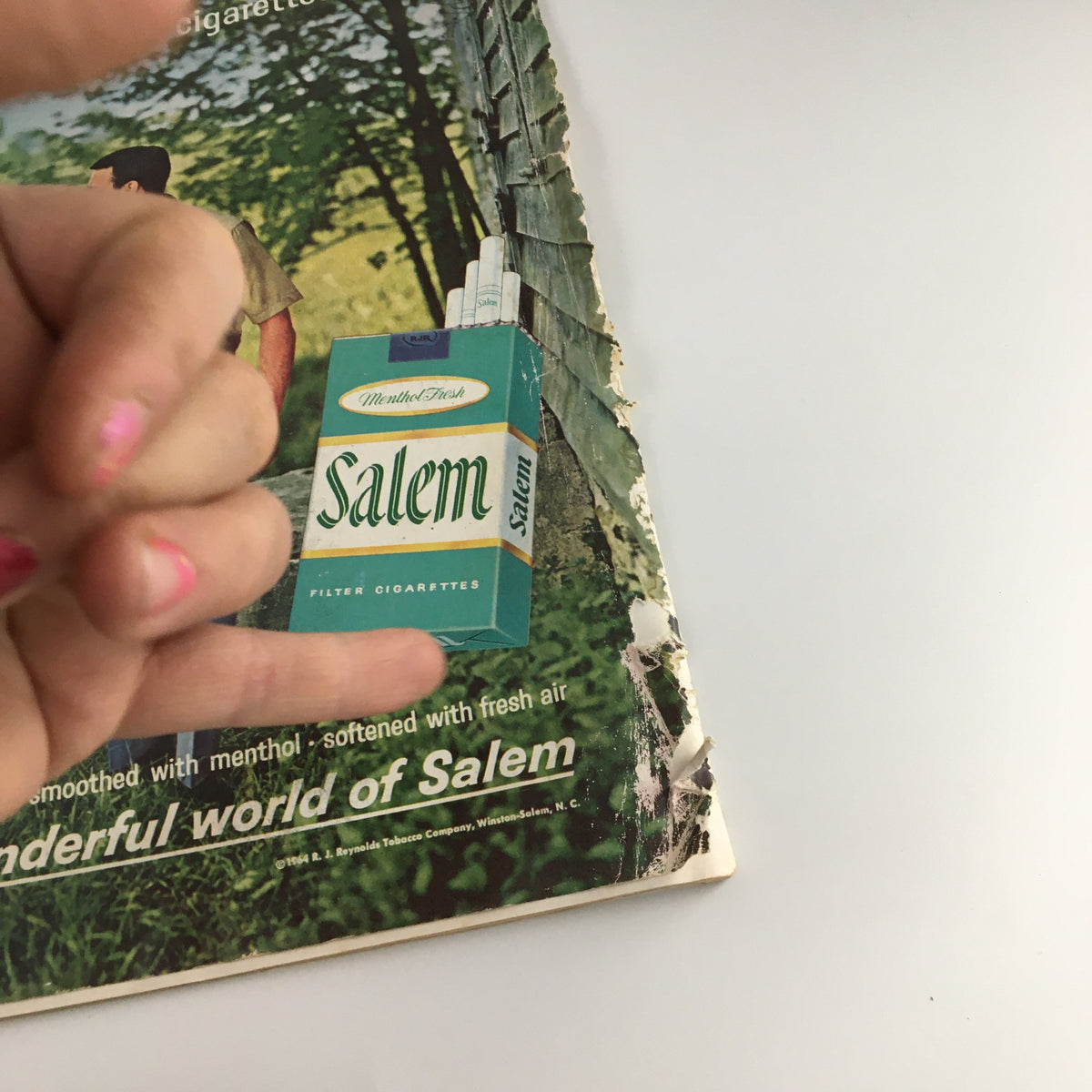 Close-up view of Salem cigarette advertisement in The Saturday Evening Post December 12, 1964, highlighting branding and product.