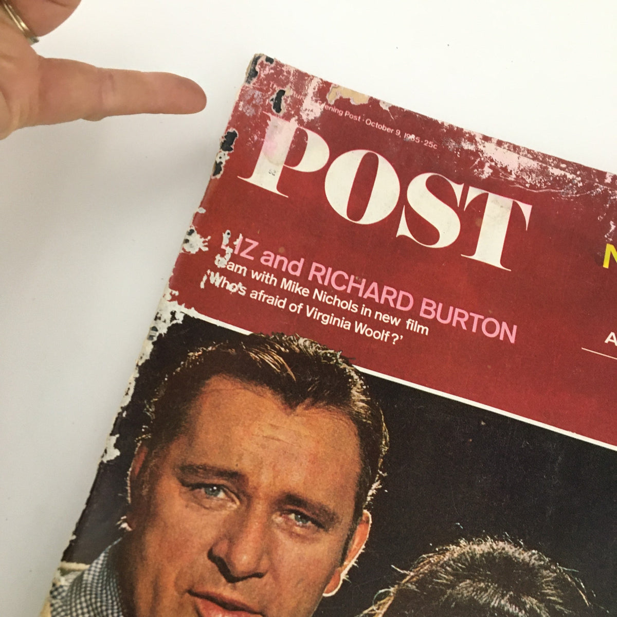 Close-up of The Saturday Evening Post October 9, 1965 with focus on the title and issue details, highlighting vintage wear and tear.