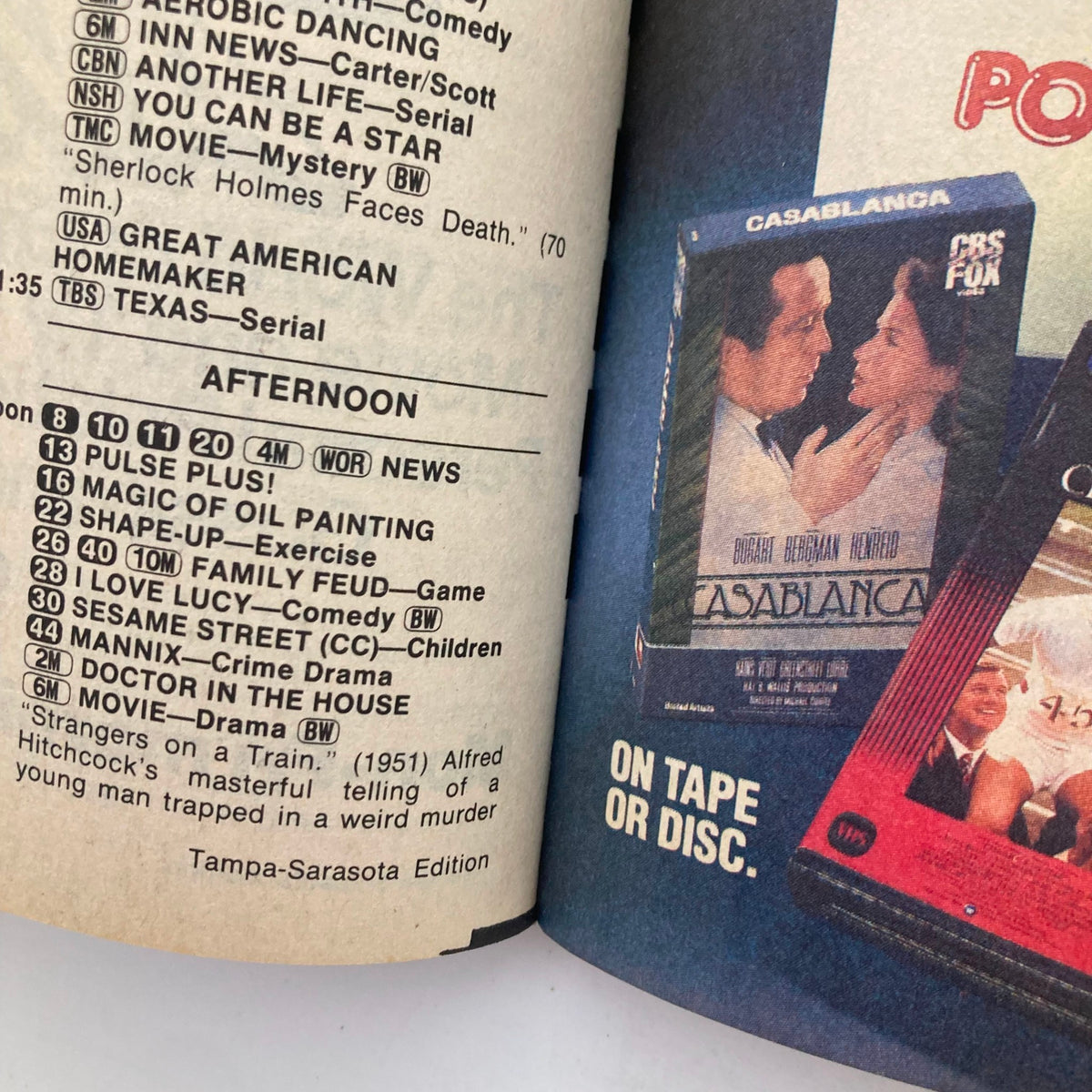 Interior page of TV Guide Magazine from February 18, 1984, displaying the programming schedule for Tampa-Sarasota, including scenes from classic shows like 'I Love Lucy' and movies like 'Casablanca'.