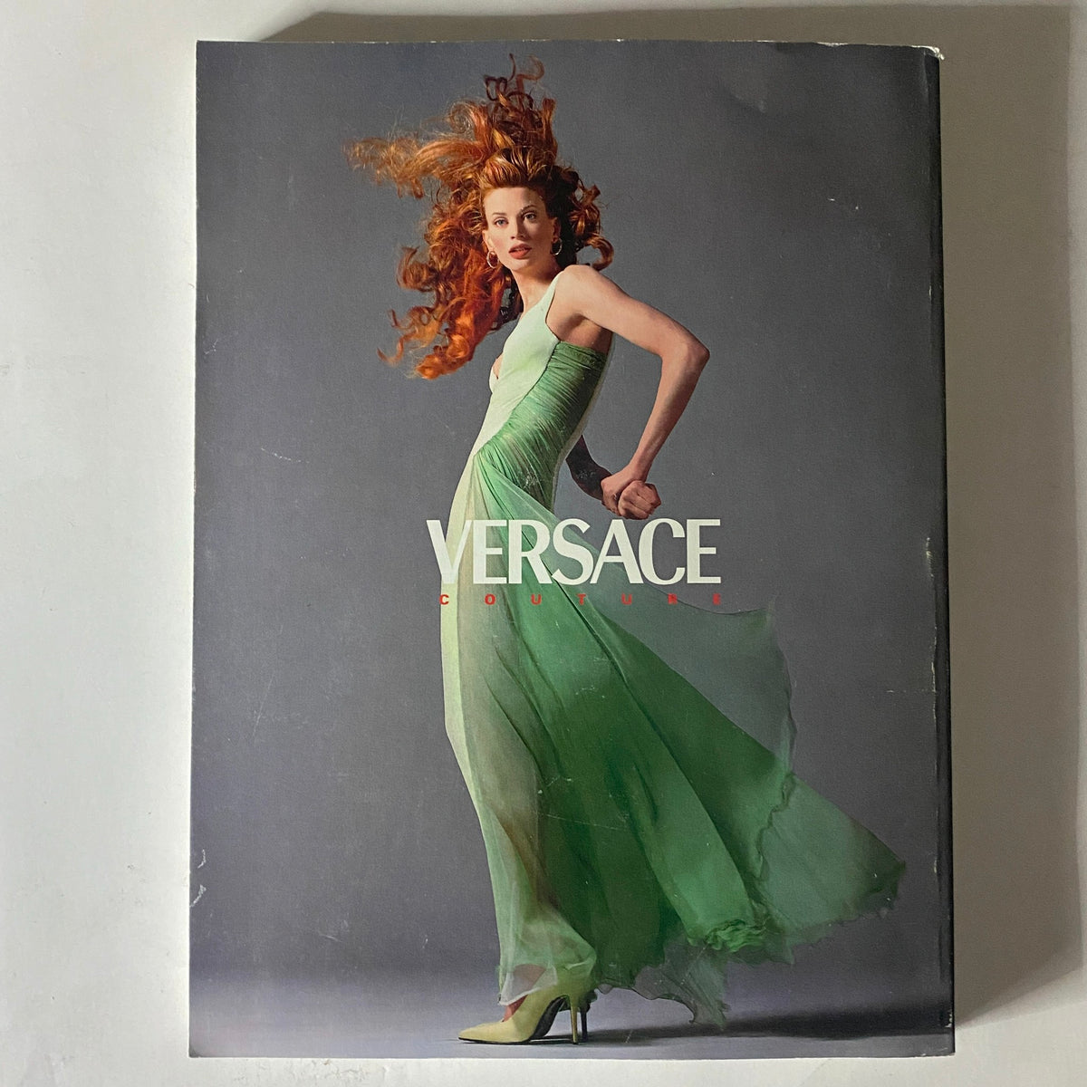 Back cover of Vogue Magazine November 1995 showcasing a Versace couture dress, highlighting luxurious fashion of the era with a flowing green gown.