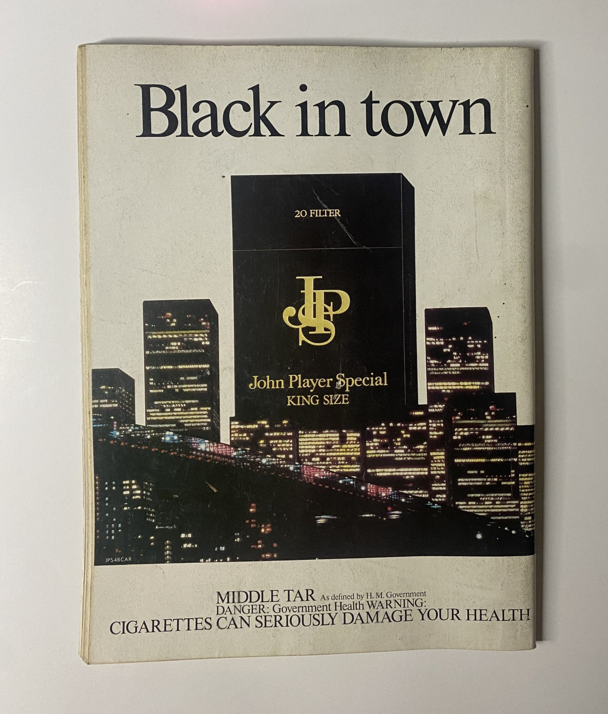 Cover of Car Magazine October 1984 showcasing a cigarette advertisement for John Player Special with a city skyline, titled 'Black in Town'.
