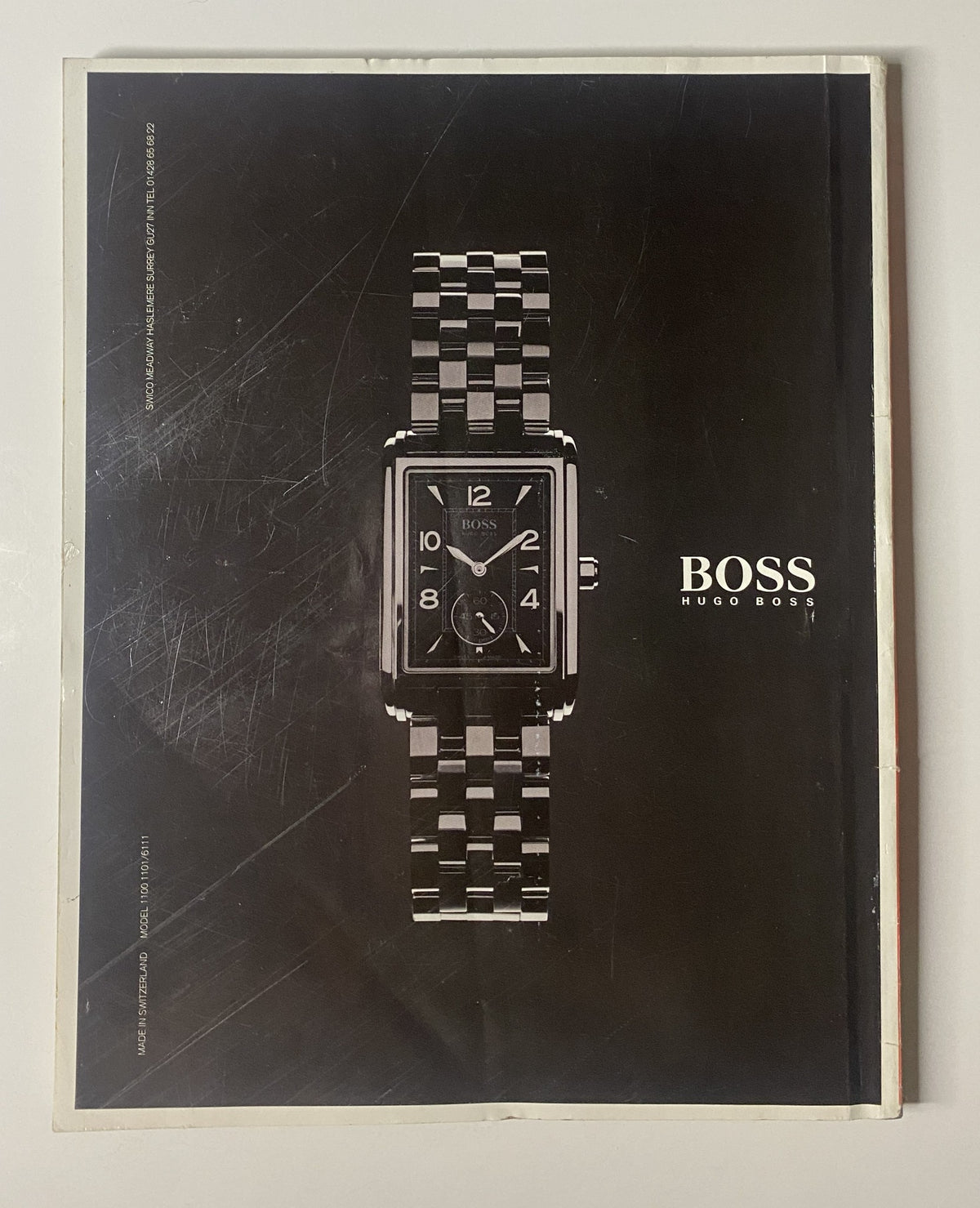 Back cover of Car Magazine October 2001 advertising a Hugo Boss wristwatch, showcasing a stylish black rectangular watch with a metal band, promoting luxury and elegance.
