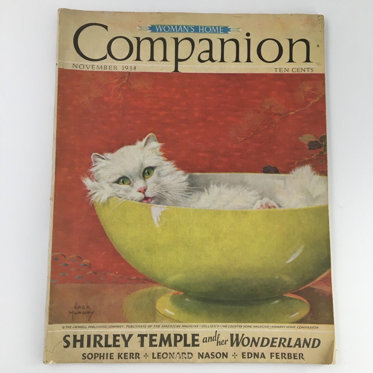 Vintage Woman's Home Companion Magazine from November 1938 featuring Shirley Temple, with a whimsical cover illustration of a white cat in a bowl against a vibrant red background.
