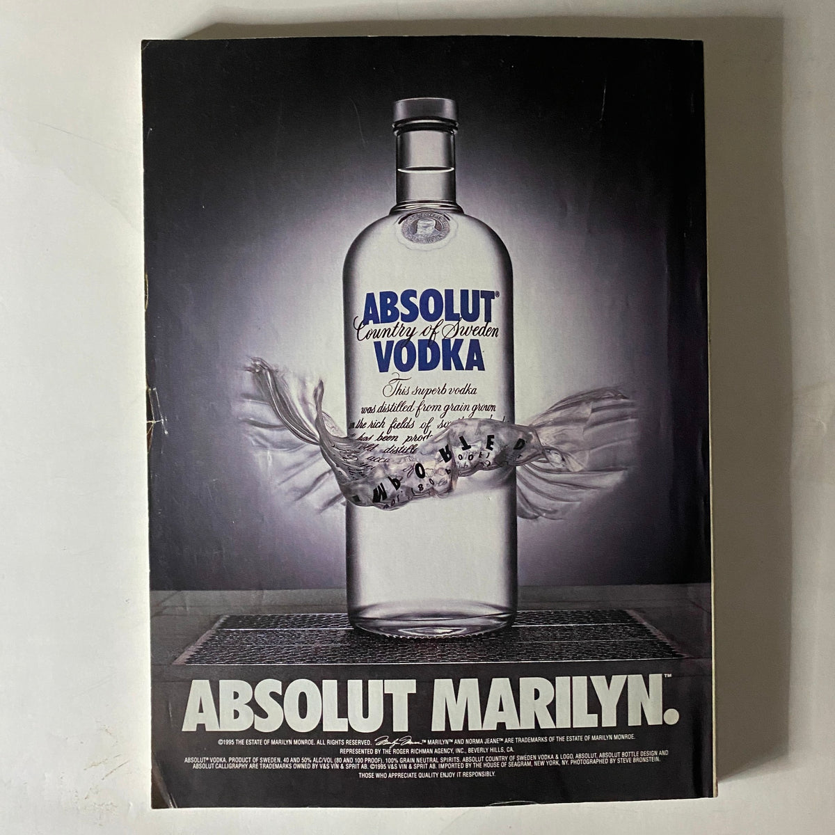 Advertisement from Vogue Magazine February 1996 for Absolut Vodka, presenting a sleek bottle with creative design elements highlighting its branding.