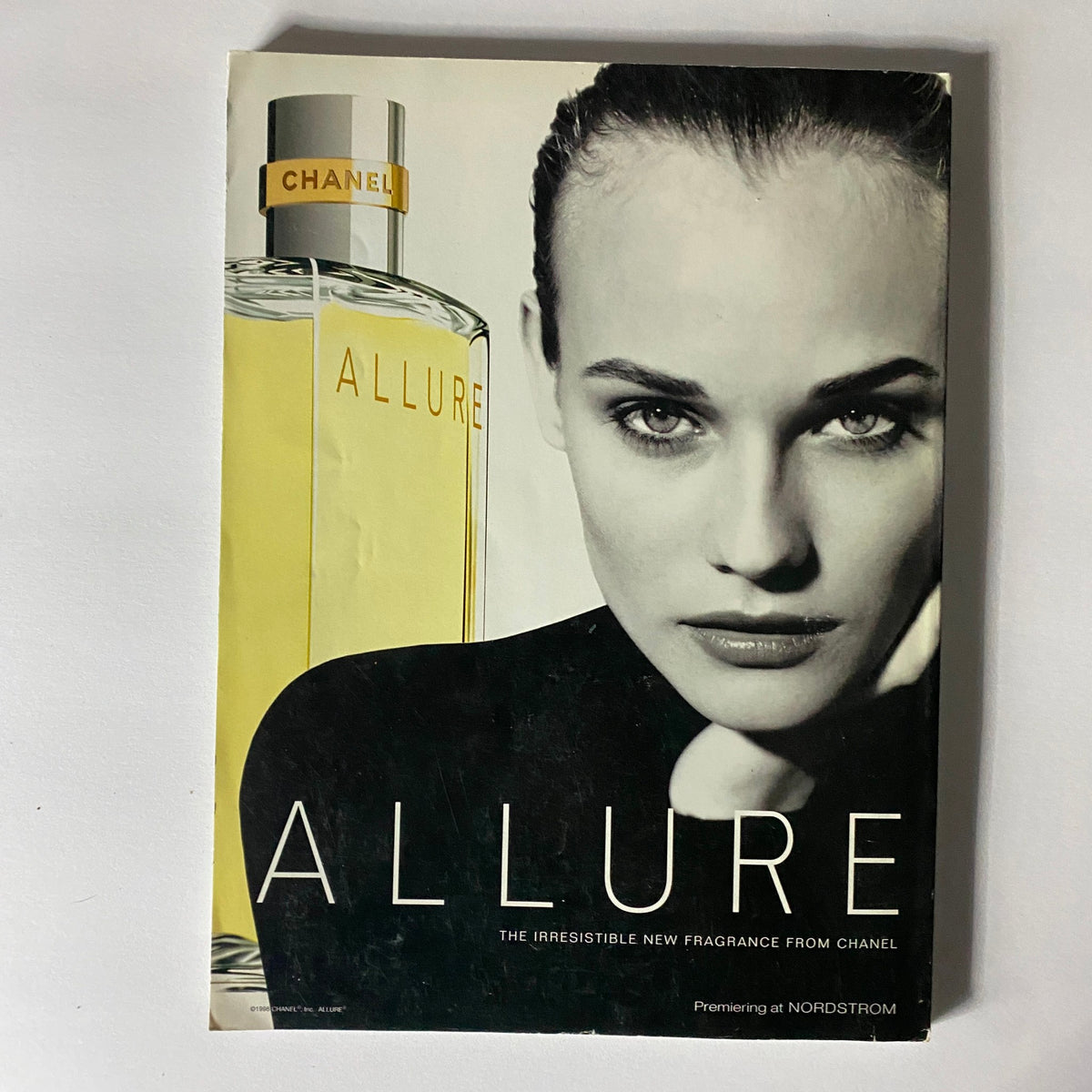 Chanel Allure fragrance advertisement from Vogue Magazine June 1996, highlighting a striking model with the allure perfume in a captivating black and white design.
