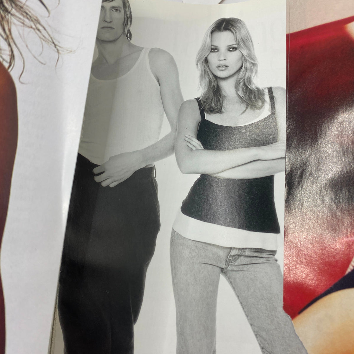Page from Vogue Magazine August 1997 displaying a striking black and white photo of a male and female model. The male model is wearing a tank top while the female model showcases a layered casual outfit, embodying the fashion trends of that era.