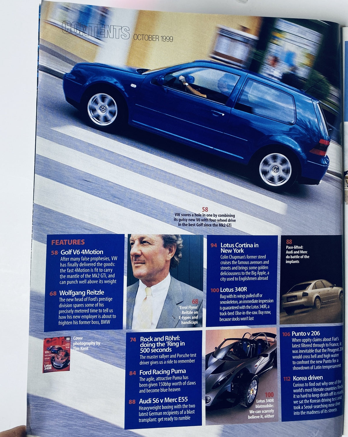 Car Magazine October 1999 featuring the VW Golf V6 4Motion, showcasing the sleek blue model on city streets, highlighting its agility and performance.