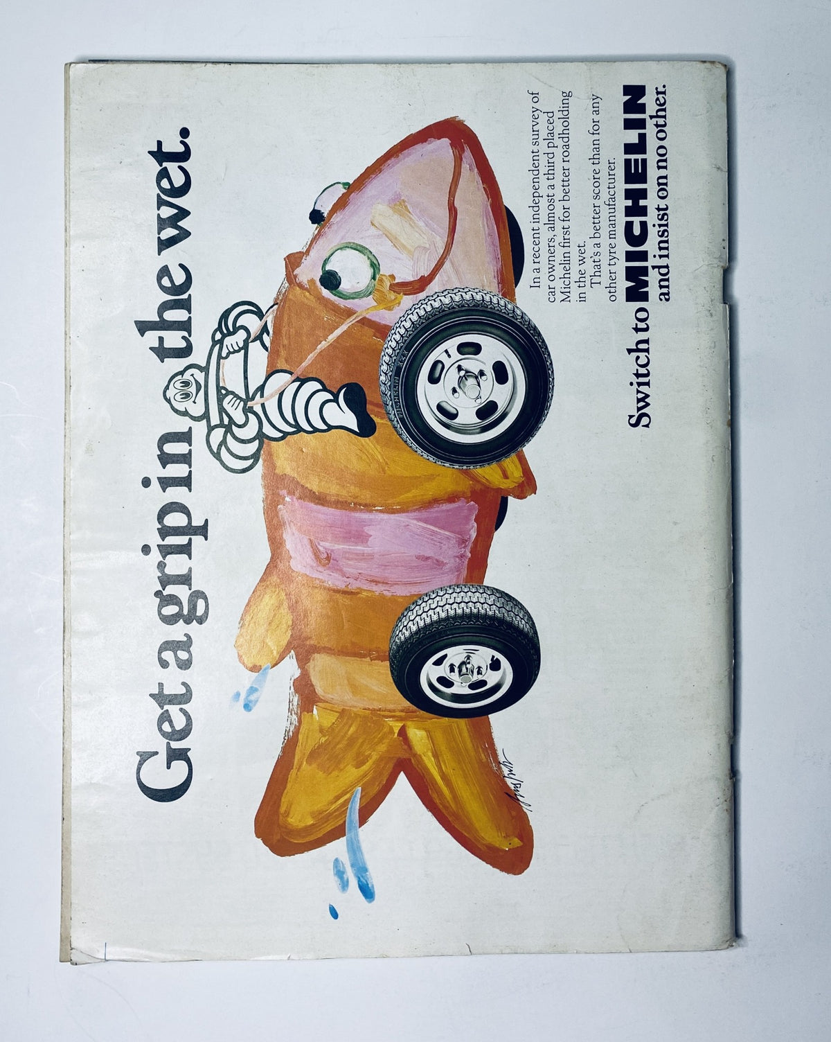 Back cover of CAR Magazine November 1982 featuring a whimsical advertisement with a cartoon fish, promoting Michelin tires with the message 'Get a grip in the wet.' This playful design draws attention to tire safety and performance.