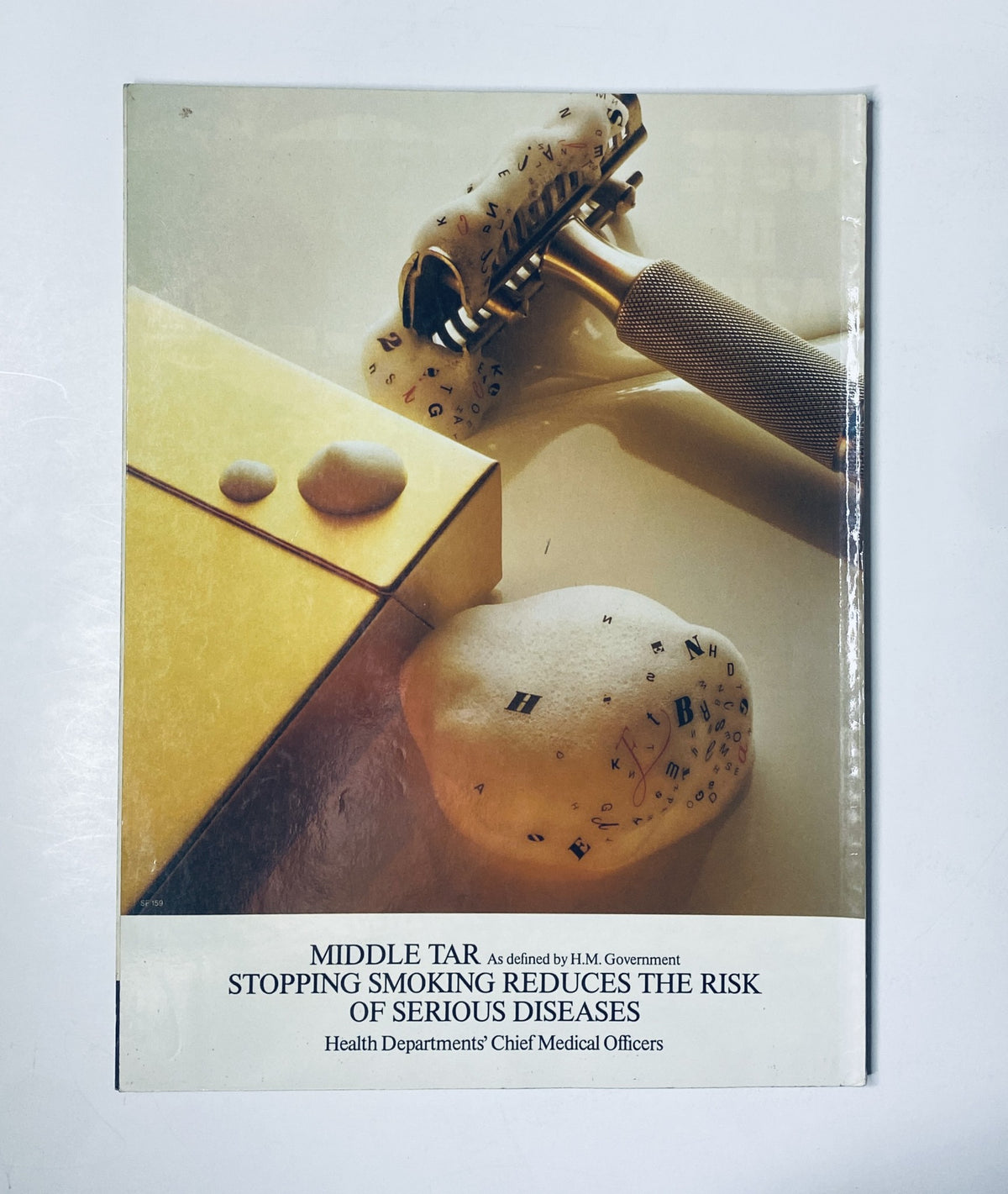 Cover of a health-related brochure titled 'Middle Tar: Stopping Smoking Reduces the Risk of Serious Diseases' with a background of odd-shaped objects.