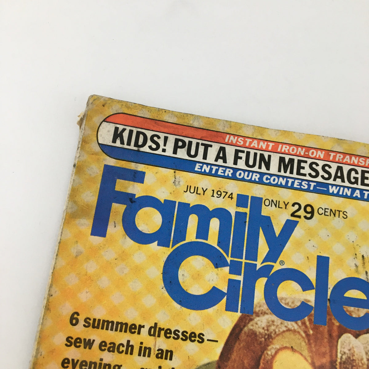 Close-up of the cover of VTG Family Circle Magazine July 1974, highlighting the magazine's title and an advertisement for kids on the top.