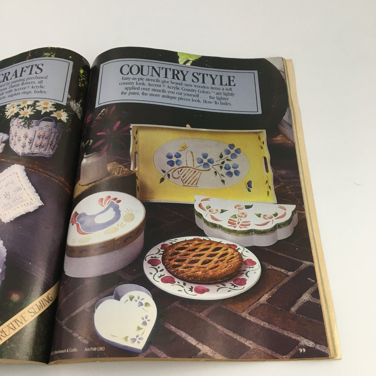 McCall's Needlework & Crafts Magazine February 1983 presents Country Crafts, displaying decorative wooden items and beautifully painted craft projects.