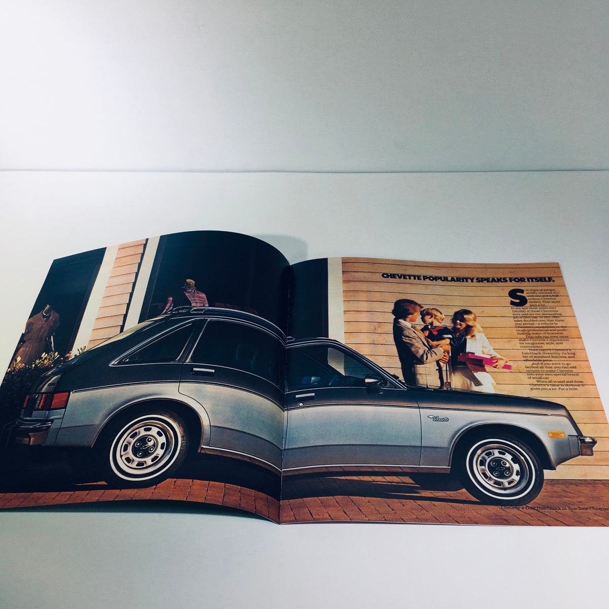Inside page of the 1982 Chevrolet Chevette 4089 brochure showcasing a silver Chevrolet Chevette parked beside a family, highlighting its practicality and appeal.