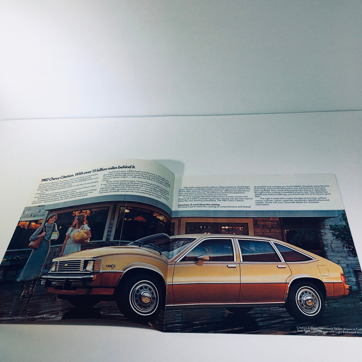 Interior view of the 1982 Chevrolet Citation 4-Door Hatchback Sedan as displayed in the August 1981 car sales brochure, featuring a golden exterior and lifestyle setting.