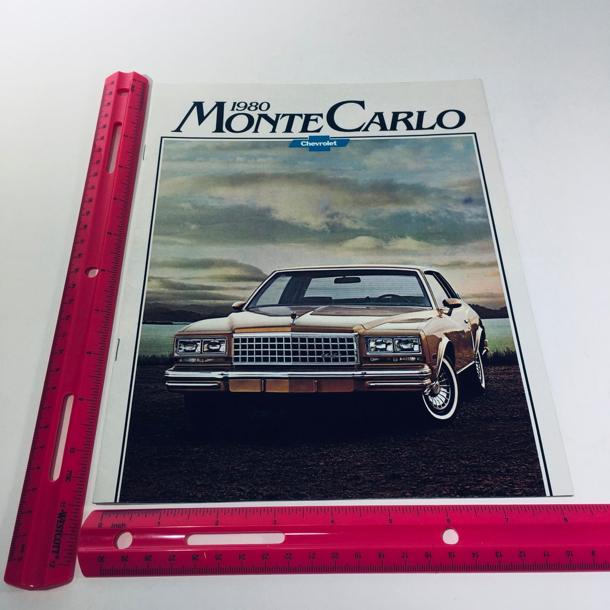 Cover image of the 1980 Chevrolet Monte Carlo Turbocharge V6 car sale brochure featuring the iconic vehicle in a scenic background, dated August 1979.