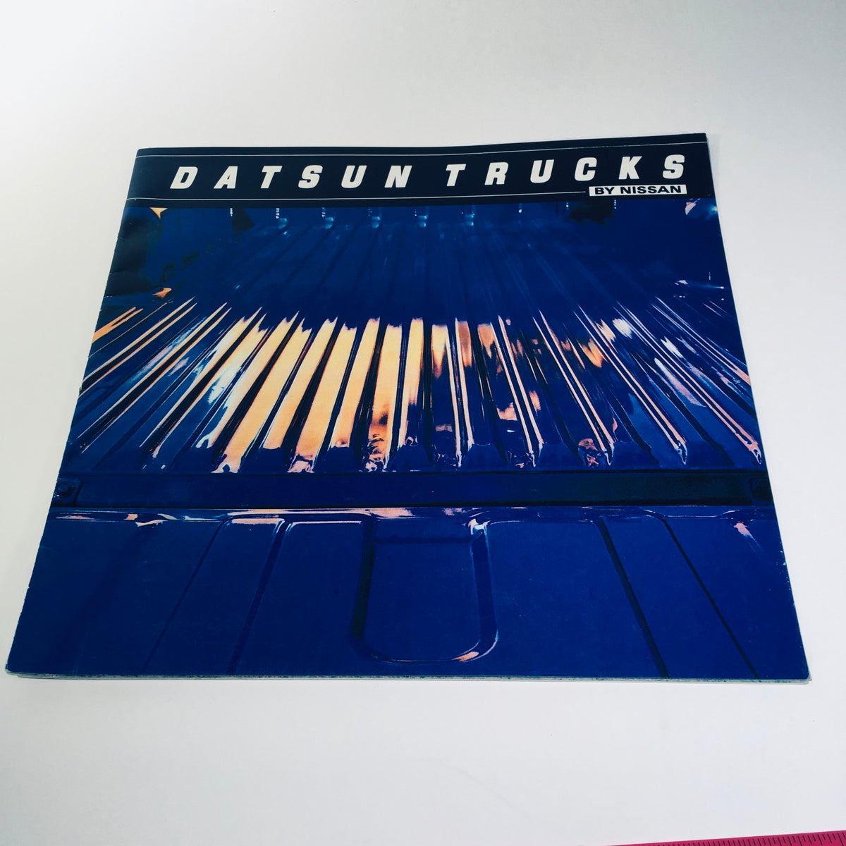 Cover of the 1981 Datsun Trucks By Nissan brochure showcasing the sleek design and colors of Datsun trucks, emphasizing the brand's aesthetic appeal.