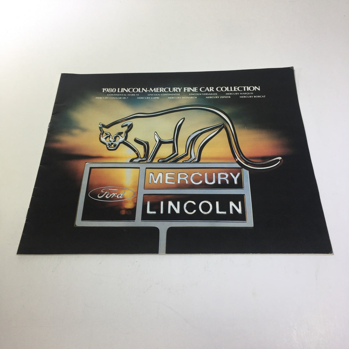 1980 Lincoln-Mercury Collection Lincoln Continental Town Coupe Car Sale Brochure cover featuring a stylized panther and car dealership signs for Mercury and Lincoln.
