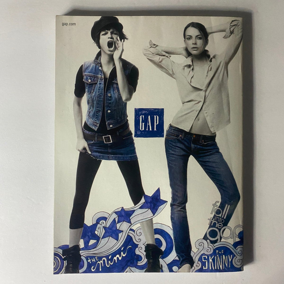 Elle Magazine August 2006 features a fashion advertisement for GAP showcasing a stylish denim ensemble and poses promoting trendy fall looks.