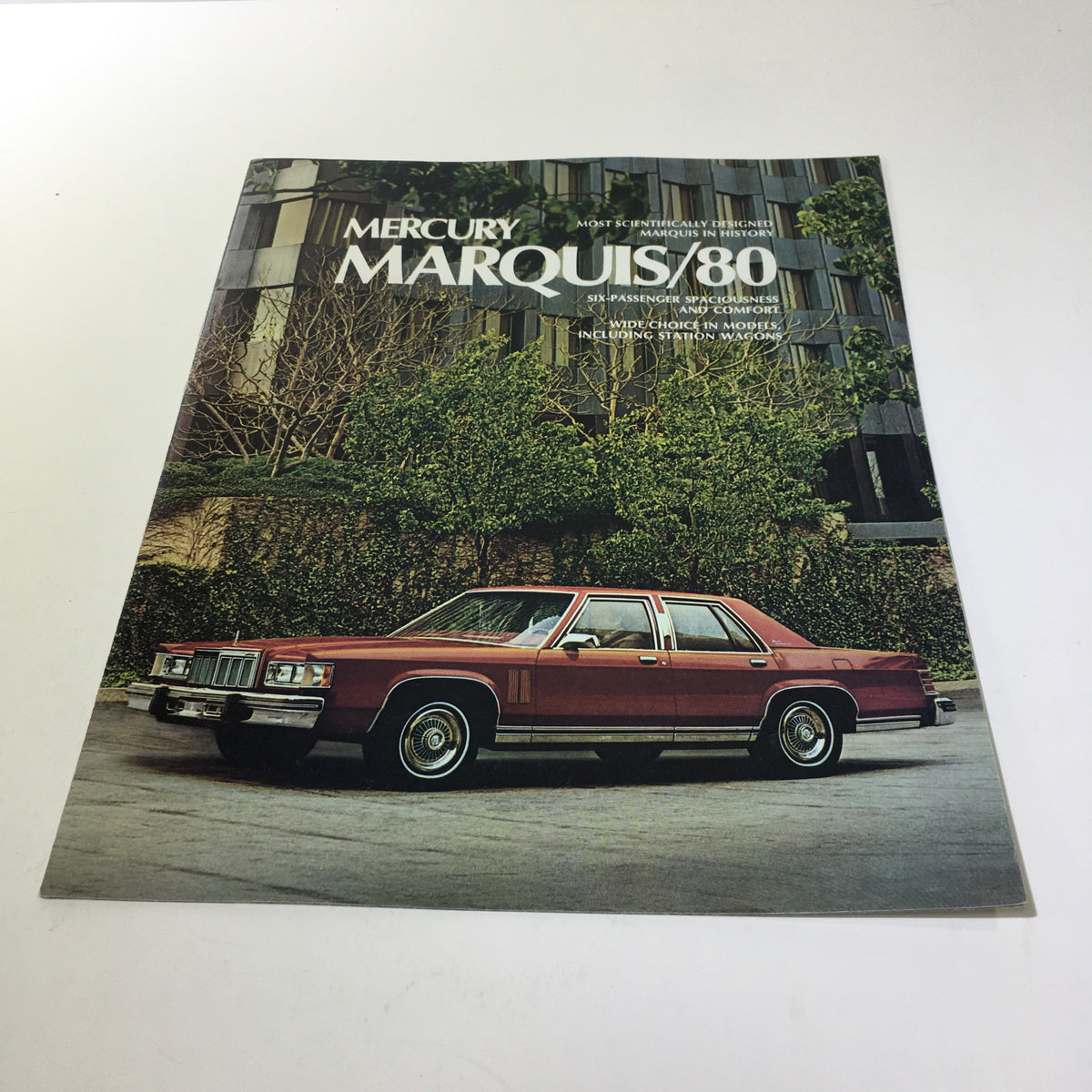 1980 T980 Mercury Marquis 5.2 Liter 302 CID V-8 Engine Car Sale Brochure cover featuring a red Mercury Marquis parked in front of a modern building.