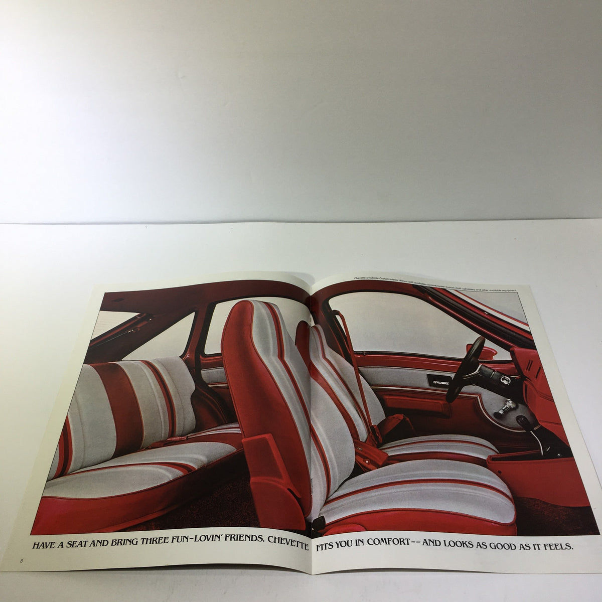 Interior page of 1980 Chevrolet Chevette brochure showcasing comfortable seating arrangement with red and white upholstery.