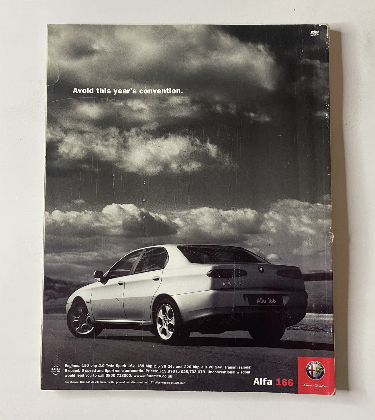Car Magazine featuring the Alfa 166 with a focus on its design, rear view, and a dramatic cloudy sky. This issue from June 2001 also includes a first drive of the New Mini, reviews of the Jaguar X-Type, and Peugeot 307.