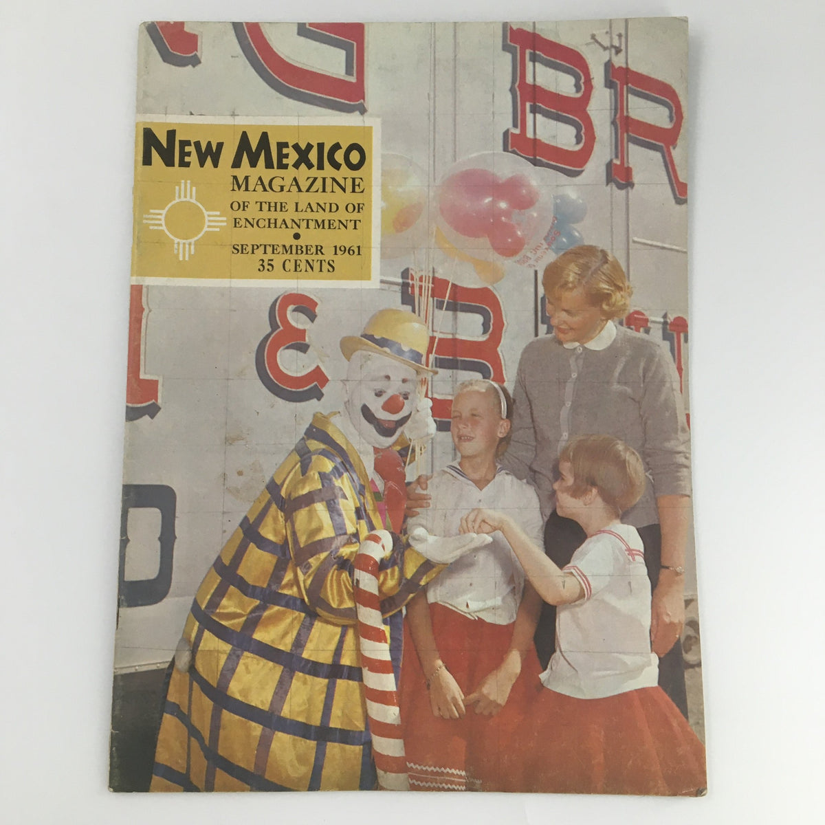 Cover of New Mexico Magazine, September 1961, featuring a clown and children, showcasing the theme 'The Land of Enchantment'.
