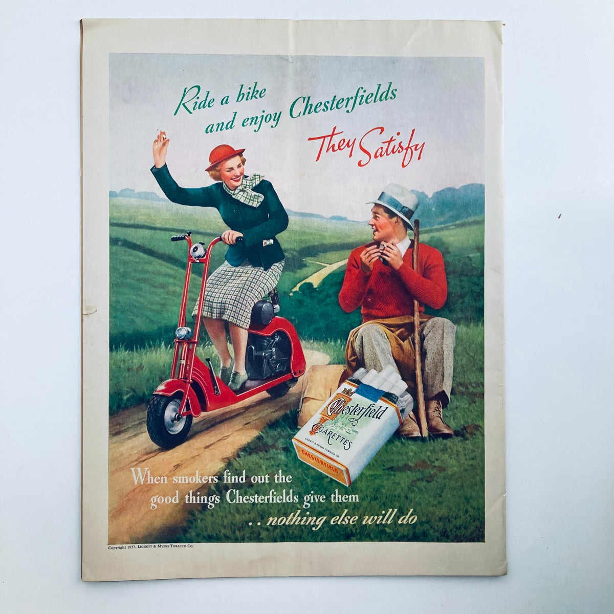 Advertisement in VTG Columbia Magazine April 1937 promoting Chesterfield cigarettes with a vintage illustration of a couple outdoors.