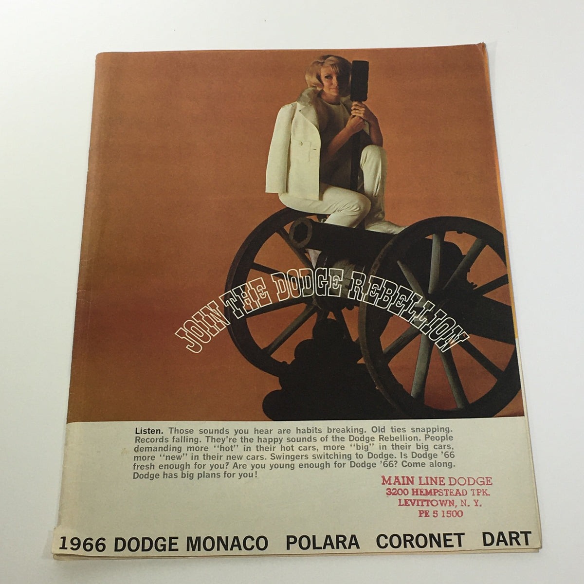 Front cover of the 1966 Dodge Monaco Polara Coronet Dart brochure featuring a model seated on a cannon, promoting the Dodge Rebellion.