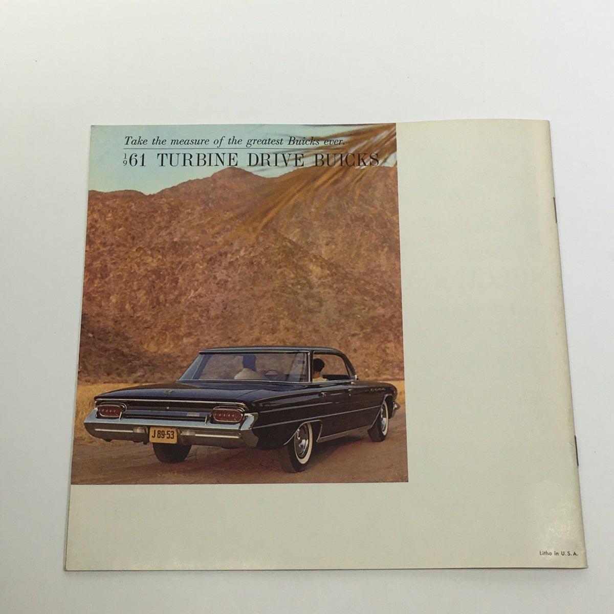 1961 Full Size Turbine Drive Buicks 4-Door and 2-Door Sedan Car Sale Brochure displaying a black Buick against a scenic desert backdrop, promoting the luxurious design of the vehicle.
