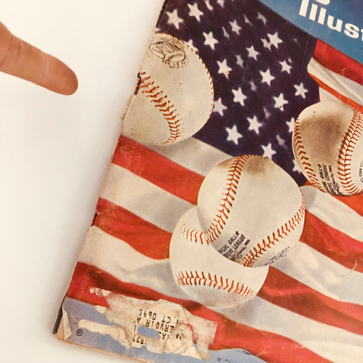 Close-up of the Vintage Sports Illustrated magazine cover from April 19, 1965, highlighting baseballs and part of the American flag, illustrating the Major League Baseball preview.