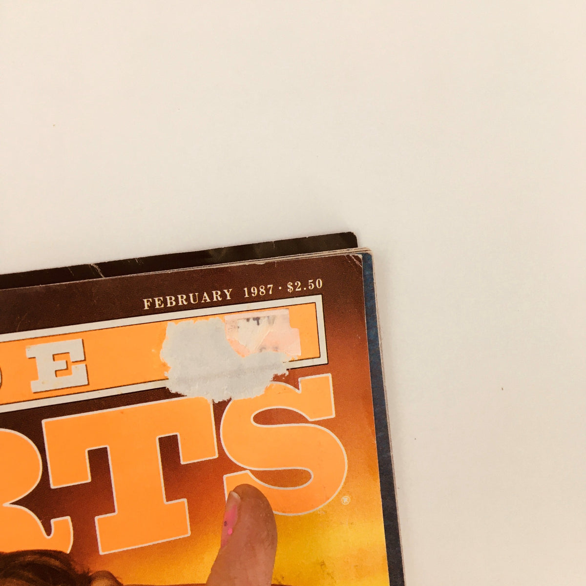 Close-up of Inside Sports Magazine February 1987 cover showing the magazine title and publication date, highlighting its collectible nature.