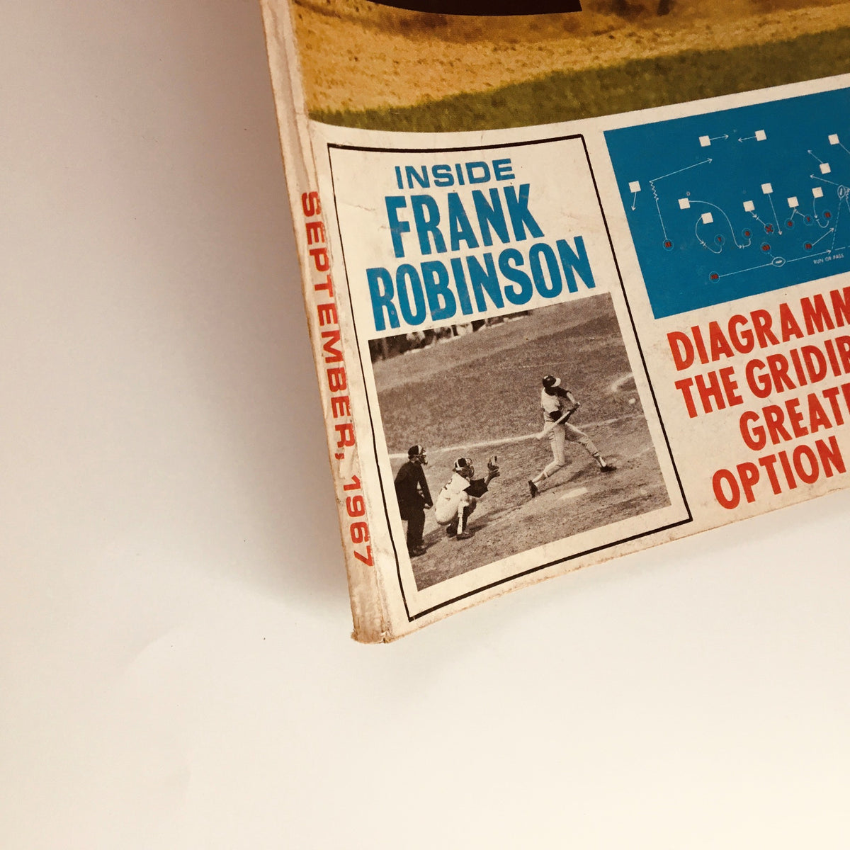 Close-up view of the VTG Pro Sports Magazine September 1967, highlighting the inside features including Frank Robinson and a diagram of football plays, encapsulating the essence of vintage sports culture.