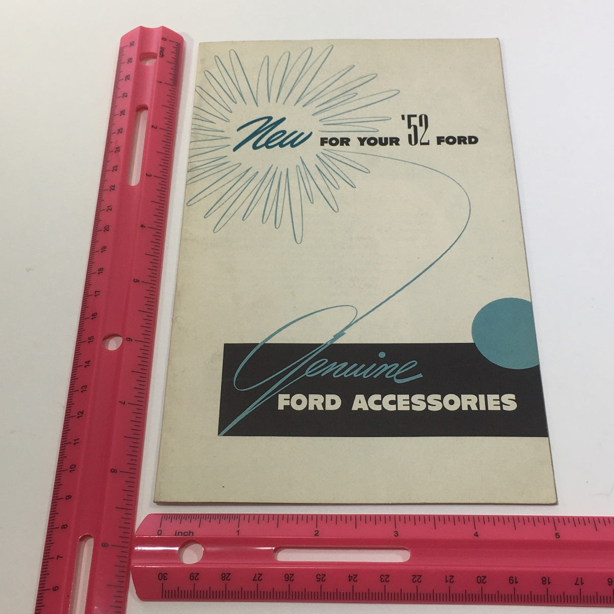 1952 Ford Genuine Accessories Magic Air System Defroster Car Catalog Brochure displayed with a ruler for size reference, emphasizing its compact design.