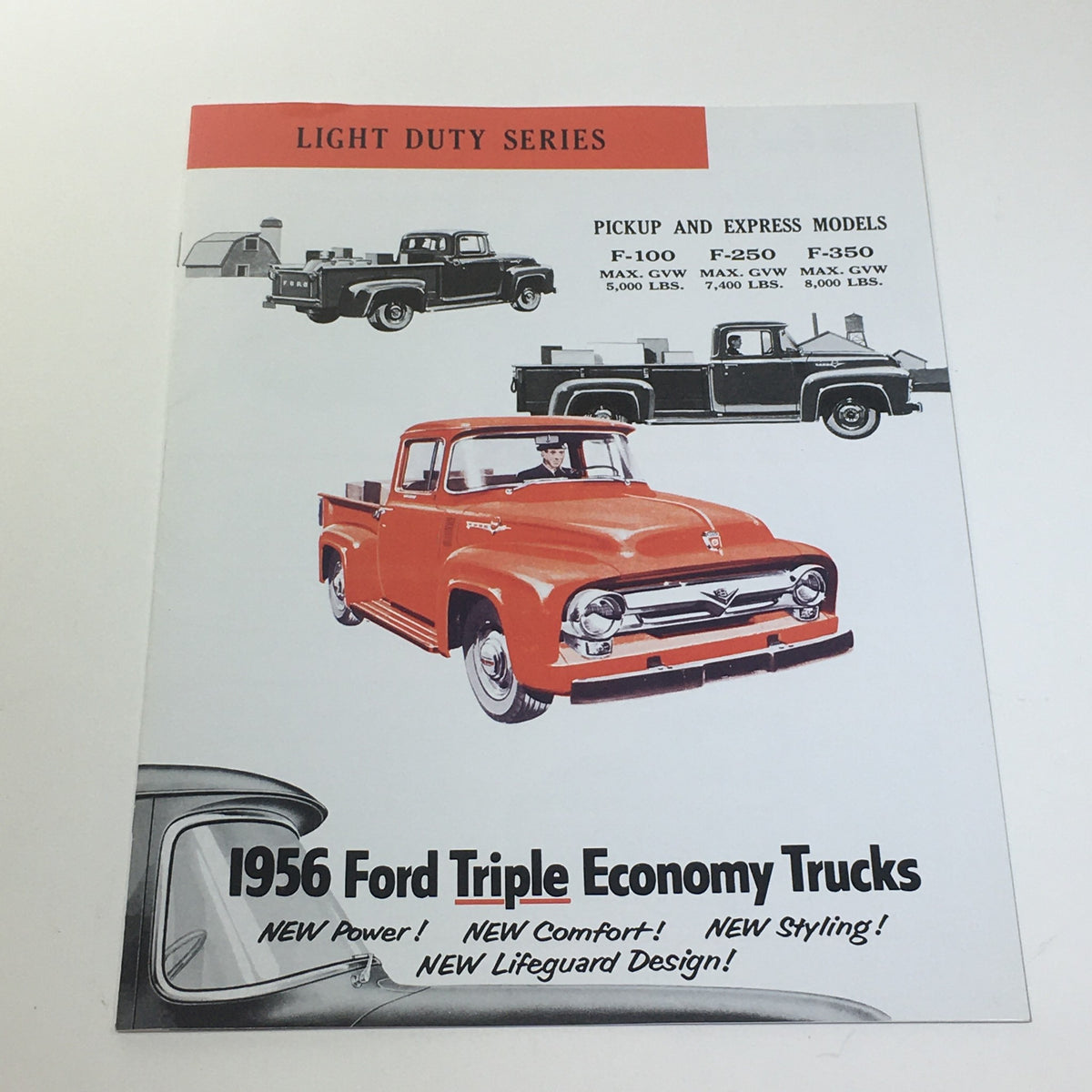 1956 Ford Triple Economy Trucks Light Duty Series F-100 250 350 Catalog Brochure featuring an illustration of the orange F-100 truck and specifications for pickup and express models including F-250 and F-350.